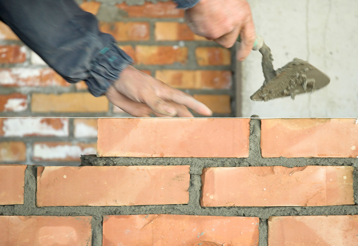 builder building a brick wall